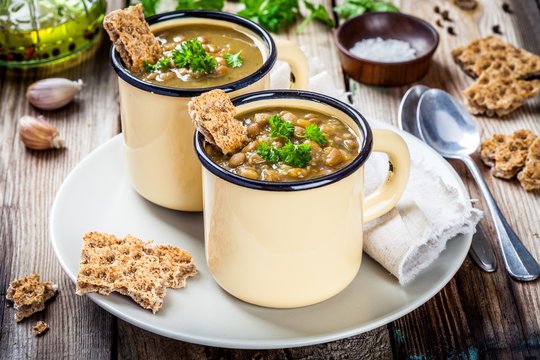 Homemade lentil soup with crispbread and parsley
