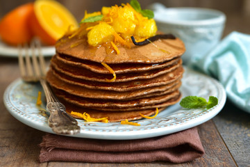 Chocolate pancakes with oranges.