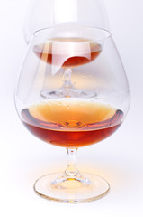Glass with cognac on white