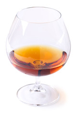 Glass with cognac on white background