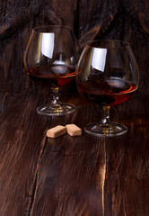 Chocolate truffles with cognac glass on the table