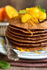 Chocolate pancakes with oranges.
