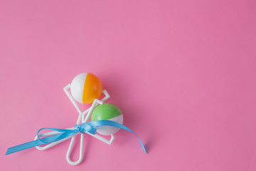 Baby toys on pink bakground.