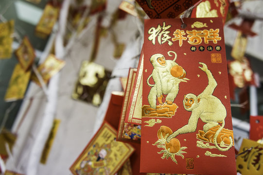 card with the image of a monkey hanging on a Christmas tree. TET coming soon. Chinese New Year
