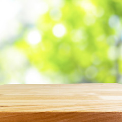 Wood table and blurry green in background
