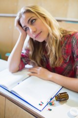 Thoughtful female student during class in lecture hall