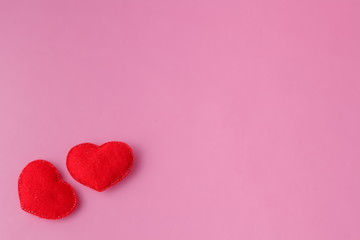 Two red heart on pink background