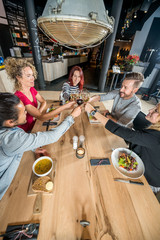 Friends Toasting Wineglasses At Table