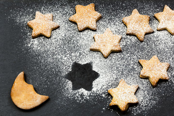 Fototapeta na wymiar stars cookies over slate simulate starry sky with moon