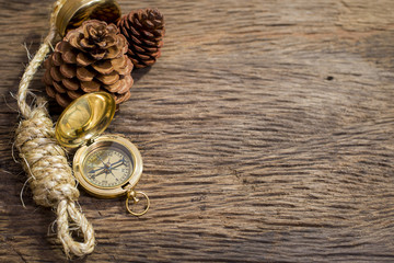 Old Compass and rope on wood background