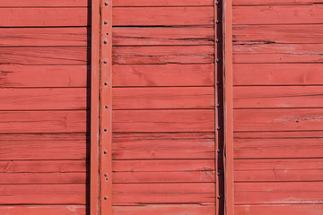 Red wooden wall of railroad wagon. Background pattern
