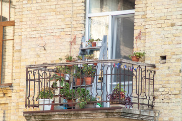 Fototapeta na wymiar balcony with blooming flowers in a brick house