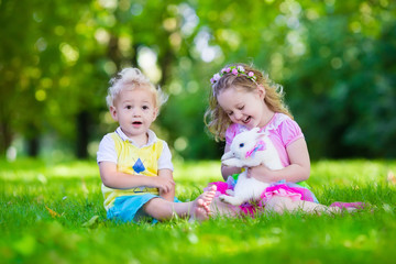 Kids playing with real rabbit