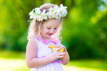 Little girl playing with a toy duck