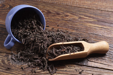 Dried black tea in scoop