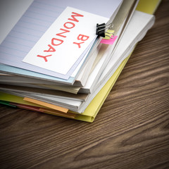 By Monday; The Pile of Business Documents on the Desk