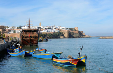 Obraz na płótnie Canvas Rabat, Morocco - December 26, 2015: Kasbah of the Udayas in Rabat. Traditional blue fishing boats in the foreground.