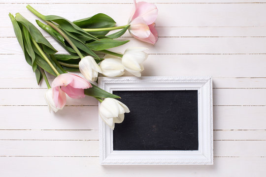 Postcard with fresh white and pink flowers and empty blackboard