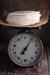Stack of wheat tortillas on vintage kitchen scales
