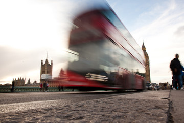 Big Ben, the Palace of Westminster, red bus and tourists moving,