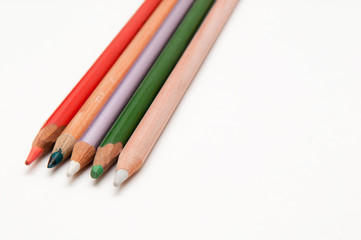 Fototapeta premium Five coloured pencils arranged on a white background