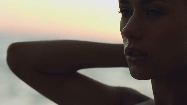 Sensual girl on the beach at sunset