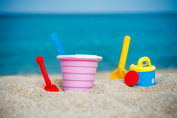 Fototapeta na wymiar Beach toys , Children's beach toys - buckets, spade and shovel on sand on a sunny day