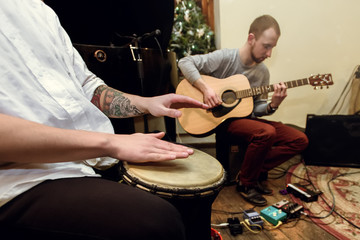 stylish solo guitarist and percussionist playing on a concert on