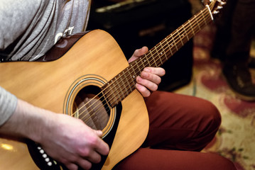 Fototapeta premium stylish solo guitarist performing on a concert on a background o