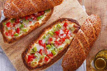 baked baguette stuffed with vegetables and cheese