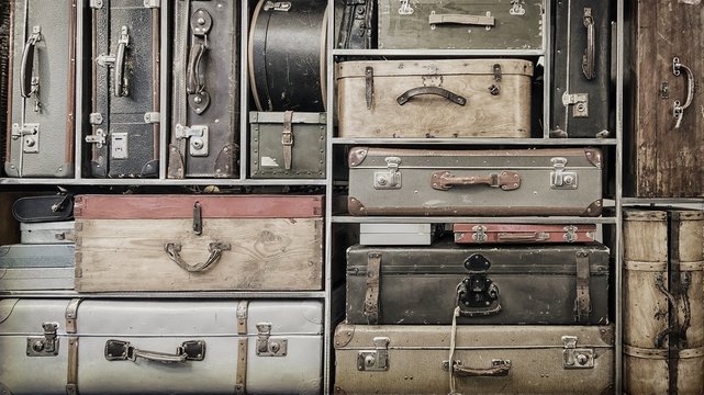 Pile of colorful vintage suitcases.