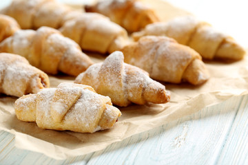 Fresh homemade croissants on a blue wooden table