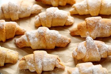 Fresh homemade croissants on a brown parchment