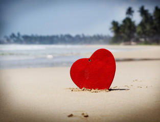 Fototapeta premium red heart on exotic sandy beach - Valentine's day concept