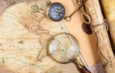 Fototapeta na wymiar An brass compass on a old map background