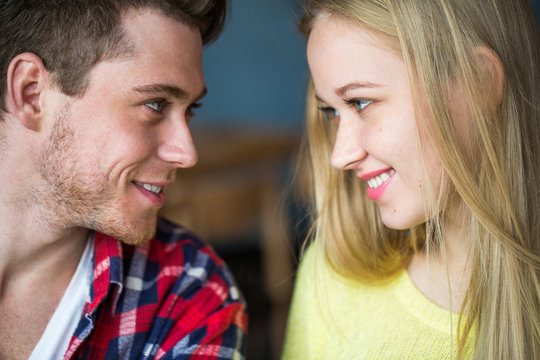 Portrait Of A Young Man And Woman Looking At Each Other