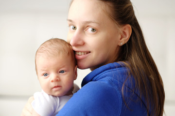 One month old newborn baby with mother