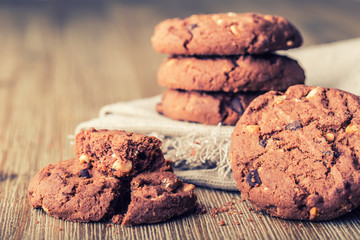 Chocolate biscuit cookies. Chocolate cookies on white linen napkin on wooden table.