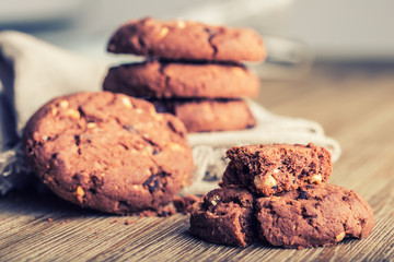 Chocolate biscuit cookies. Chocolate cookies on white linen napkin on wooden table.