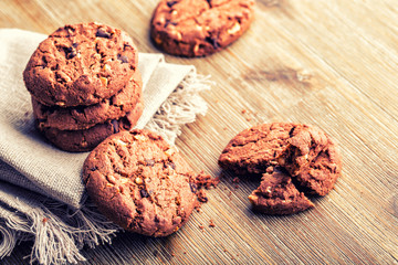 Chocolate biscuit cookies. Chocolate cookies on white linen napkin on wooden table.