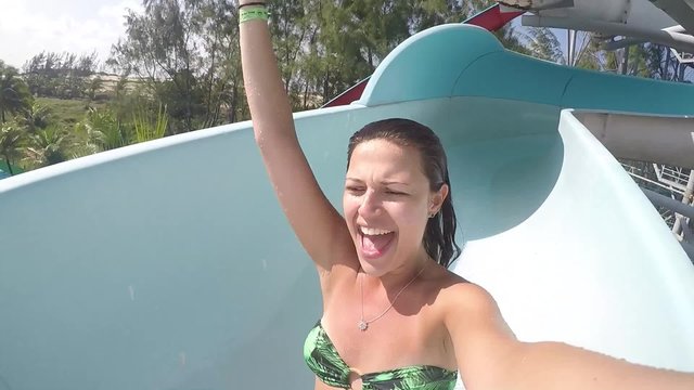Girl Sliding Down a Water Slide Tube