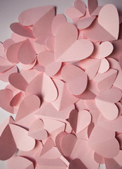 Delicate romantic background of pink paper hearts
