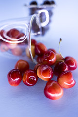 red and yellow cherries spilled from the glass
