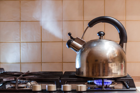 Tea Kettle With Steam Over A Hot Gas Stove Stock Photo - Download Image Now  - Kettle, Boiling, Steam - iStock