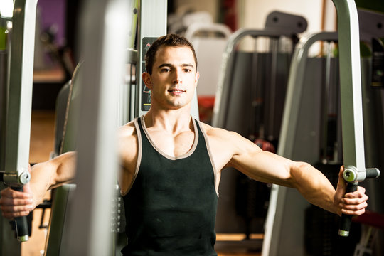 Handsom young man workout in fitness gym