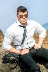 a young cute men at the beach, blue sky, gay wedding