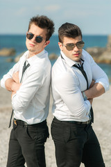 a couple young cute men at the beach, blue sky, gay wedding