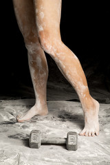 woman legs covered in white powder one heel up