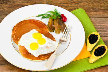 Pancakes with Quail Eggs, Cold Meats, Pastry Spoon with Black Ca