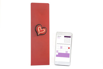 Smart phone and heart with Valentine's day marked